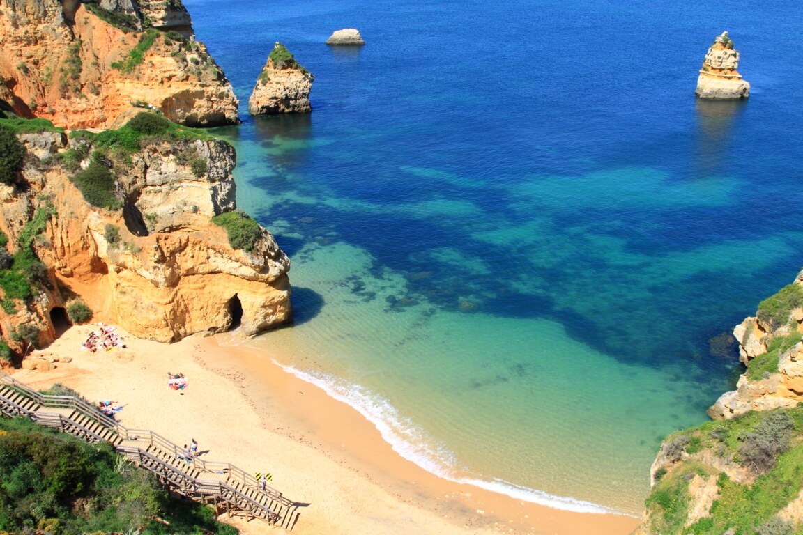 Panoramic view of Praia do Camilo from the surrounding cliffs Panoramic view of Praia do Camilo from the surrounding cliffs